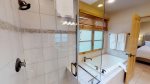 En suite master bathroom with bathtub and walk in shower 